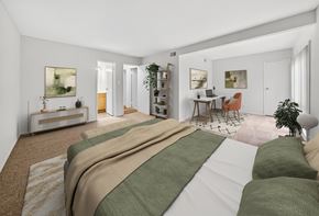Rockville apartment for rent - A bedroom with a large bed and a desk with a chair.