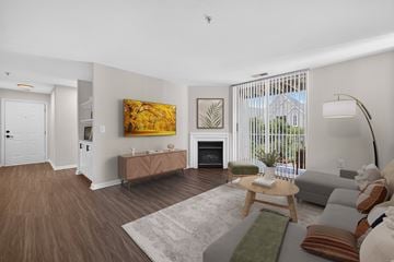 Frederick apartment for rent - A living room with a fireplace and a painting on the wall.