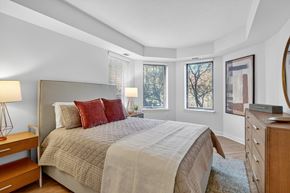 Washington apartment for rent - A bedroom with a large bed and a wooden dresser.