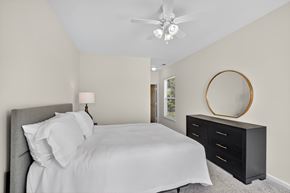 Spotsylvania apartment for rent - A classic style bedroom with a bed, dresser, and ceiling fan.
