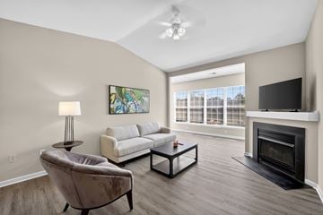 Spotsylvania apartment for rent - A living room with a fireplace and a painting on the wall.