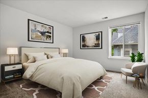 Washington apartment for rent - a bedroom with a bed and two windows