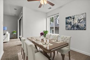 Washington apartment for rent - a dining room with a table and chairs and a ceiling fan