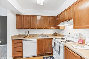 Washington apartment for rent - a kitchen with white appliances and wooden cabinets