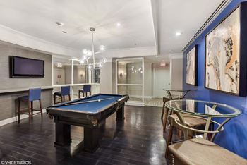 A game room with a pool table and a tv