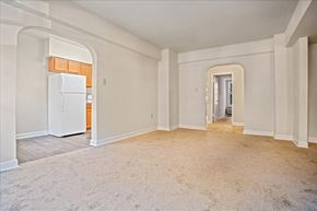 Washington apartment for rent - a renovated living room with a kitchen with a refrigerator