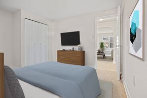 Washington apartment for rent - a bedroom with a bed and a tv on the wall