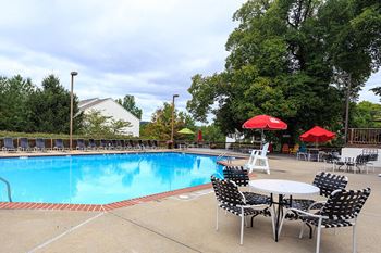 Shimmering swimming pool with 2-tier sundeck and gas grills