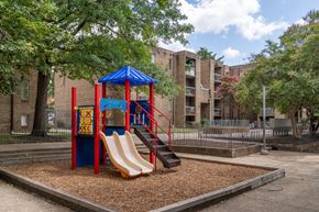 Washington apartment for rent - A playground with a blue and red structure and a yellow slide.