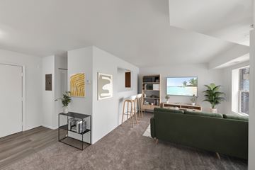 Washington apartment for rent - A living room with a green couch and a television.