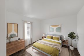 Washington apartment for rent - A bedroom with a bed, nightstand, and a painting on the wall.