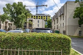 Washington apartment for rent - a construction site on a city street with cars and a fence