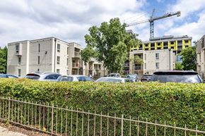 Washington apartment for rent - a parking lot in front of an apartment building with a crane