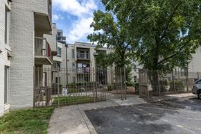 Washington apartment for rent - the yard of an apartment building with a yard behind a fence