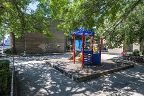 Washington apartment for rent - a playground with a blue and red swing set