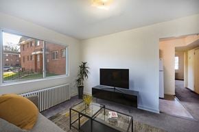 Washington apartment for rent - a living room with a large window and a television
