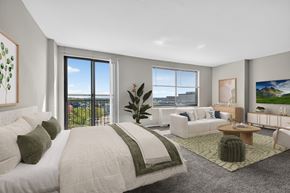 Hyattsville apartment for rent - A bedroom with a large bed and a view of the city.
