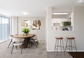 Hyattsville apartment for rent - A modern dining room with a round wooden table and white chairs.