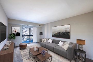 Washington apartment for rent - a living room with a gray couch and a table