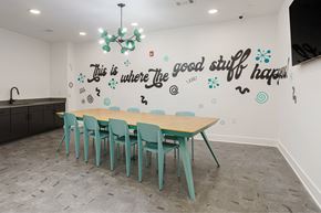 Nashville apartment for rent - A conference room with a long table and chairs and a quote on the wall.