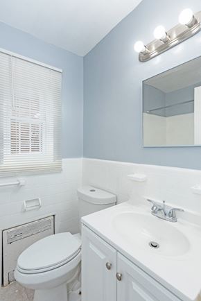 Washington apartment for rent - a bathroom with a toilet sink and mirror