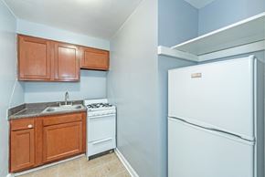 Washington apartment for rent - a kitchen with a white refrigerator freezer next to a stove top oven