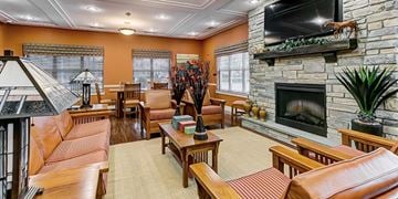 Elkton apartment for rent - A living room with a stone fireplace and a television above it.