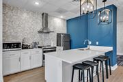 Williamsburg apartment for rent - A kitchen with a white countertop and black stools.