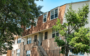 Baltimore apartment for rent - A brown building with a tree in front of it at Pleasantview Apartments, Baltimore