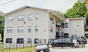 Washington apartment for rent - a picture of a three story apartment building with a black car parked in front of it