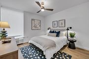 Williamsburg apartment for rent - A bedroom with a bed, a ceiling fan, and two wall lamps.