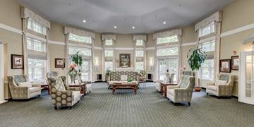 Suitland apartment for rent - a large living room filled with furniture and large windows