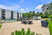 Williamsburg apartment for rent - A large outdoor patio area with a table set for dining and a pool in the background.