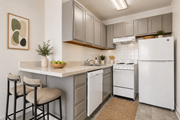College Park apartment for rent - A kitchen with white appliances and a white refrigerator.