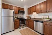 College Park apartment for rent - A kitchen with a refrigerator, microwave, oven, and sink.