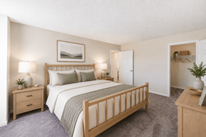 Suitland apartment for rent - A bedroom with a large bed, two nightstands, and a dresser.