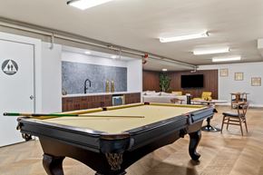 Columbia apartment for rent - A pool table in a room with a bar and a TV.