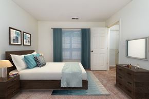 Bowie apartment for rent - bedroom with bed, curtains, mirror, and bedside table at Governors Green, Bowie, MD