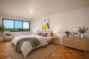 Silver Spring apartment for rent - A bedroom with a large bed, a chair, a nightstand, and a window overlooking the ocean.