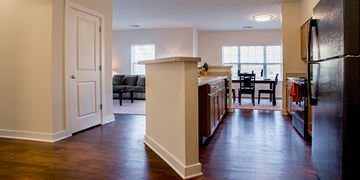 Perry Hall apartment for rent - A kitchen with a black refrigerator and wooden floors.