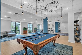 Resident lounge with full kitchen, seating, pool table and smart tv
