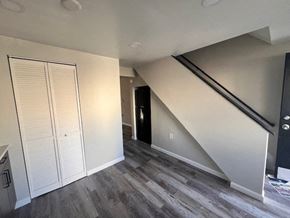 Baltimore apartment for rent - A room with a staircase leading to the upper floor at Pleasantview Apartments, Baltimore, MD, 21214