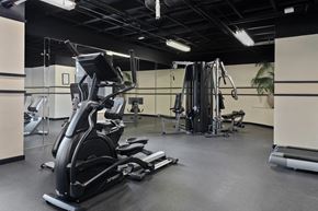 Fort Washington apartment for rent - A gym with a variety of equipment including treadmills, weights, and exercise machines.