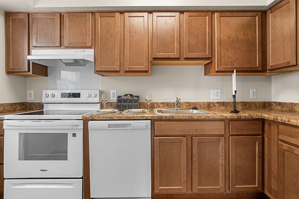 Silver Spring apartment for rent - A kitchen with brown cabinets and white appliances.