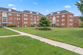 Silver Spring apartment for rent - A large red brick building with a green lawn in front.