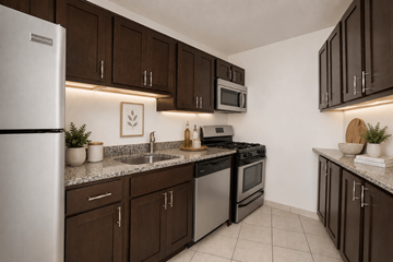 Silver Spring apartment for rent - A kitchen with brown cabinets and a white refrigerator.