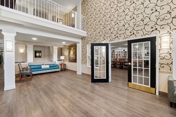 Essex apartment for rent - A living room with a blue couch and a wooden floor.