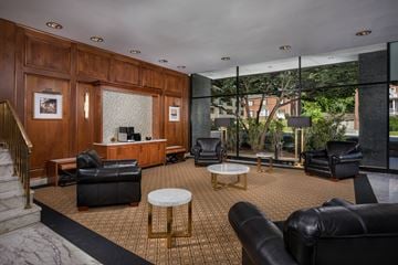 Silver Spring apartment for rent - a living room with black leather furniture and a large window