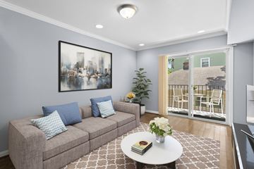 Washington apartment for rent - A living room with a grey couch, a white coffee table, and a painting on the wall.
