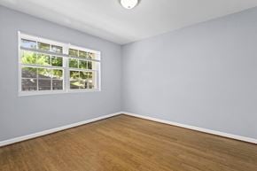 Washington apartment for rent - an empty room with hardwood floors and a large window